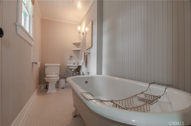 bathroom with toilet, tile patterned floors, and a bathing tub