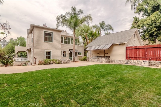 back of house with a lawn