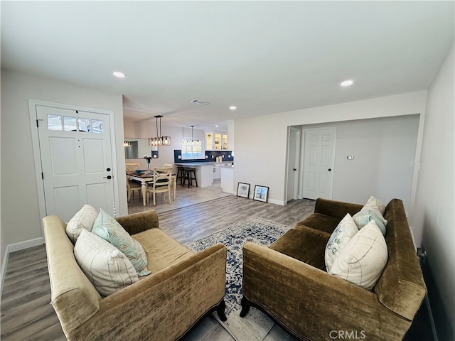 living room featuring hardwood / wood-style floors and a notable chandelier