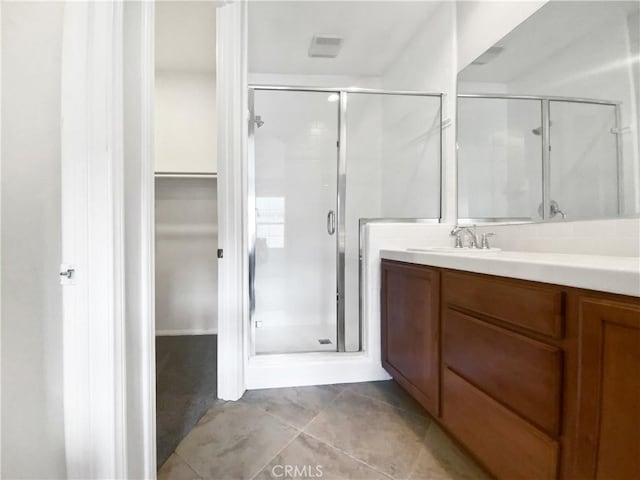 bathroom with vanity, tile patterned floors, and walk in shower