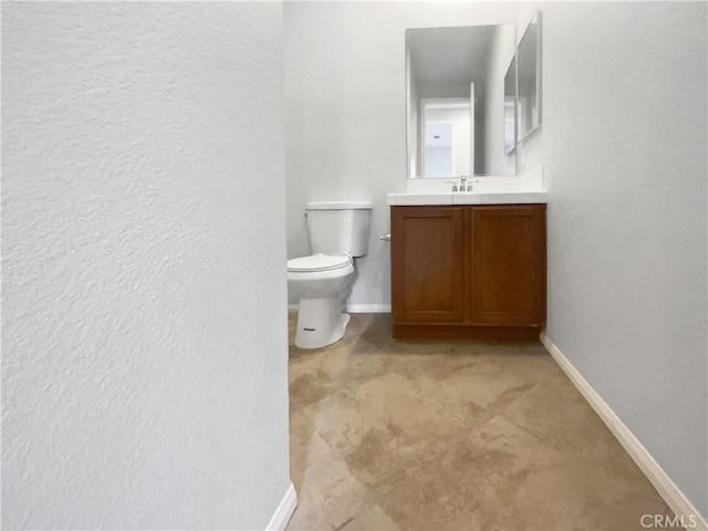 bathroom featuring toilet and vanity