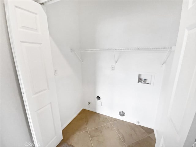 clothes washing area featuring gas dryer hookup, laundry area, hookup for a washing machine, and light tile patterned floors