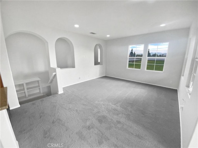 carpeted empty room featuring recessed lighting, visible vents, and baseboards