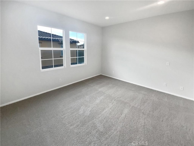 carpeted spare room featuring recessed lighting and baseboards