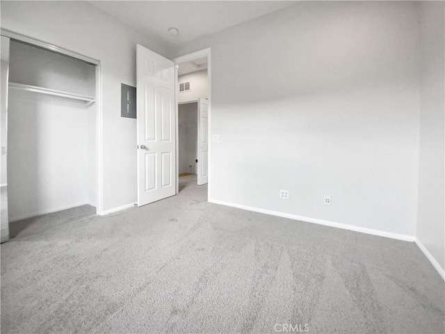 unfurnished bedroom with baseboards, visible vents, a closet, and carpet flooring