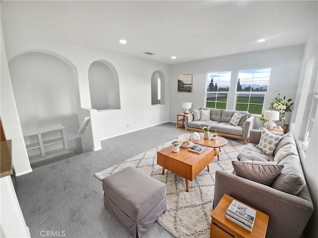 living area featuring carpet floors, recessed lighting, and visible vents