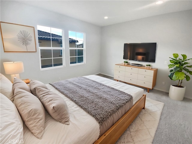 bedroom with recessed lighting, light colored carpet, and baseboards