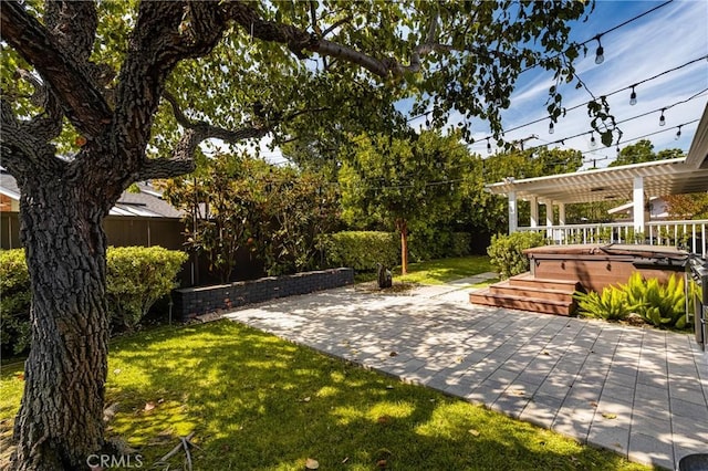 view of yard with a pergola, a patio area, and a hot tub