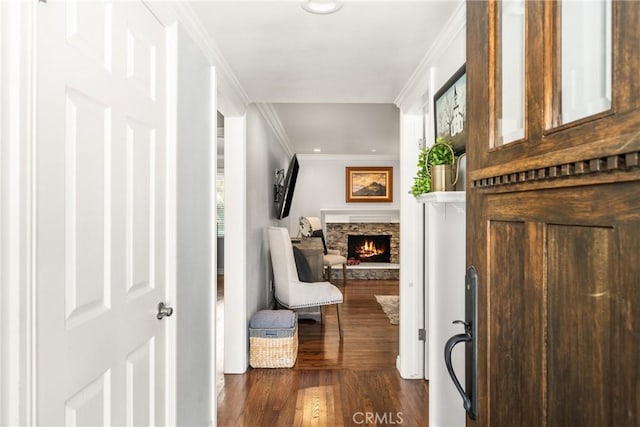 hallway with dark wood-type flooring and ornamental molding