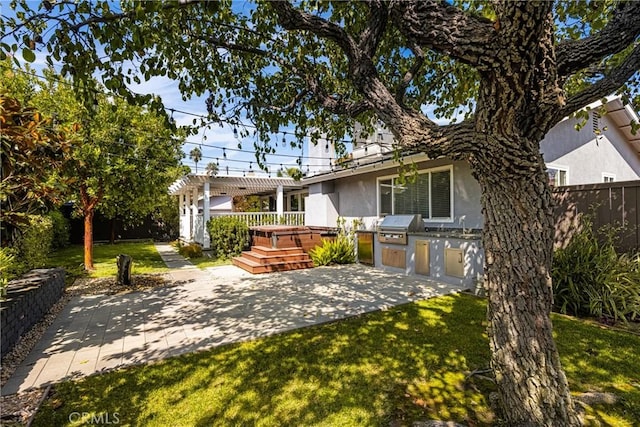 back of house with a pergola, a yard, a deck, area for grilling, and a patio