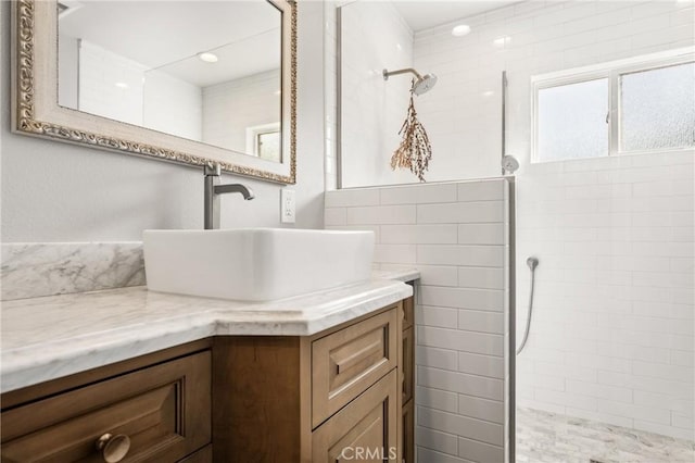 bathroom with vanity and tiled shower