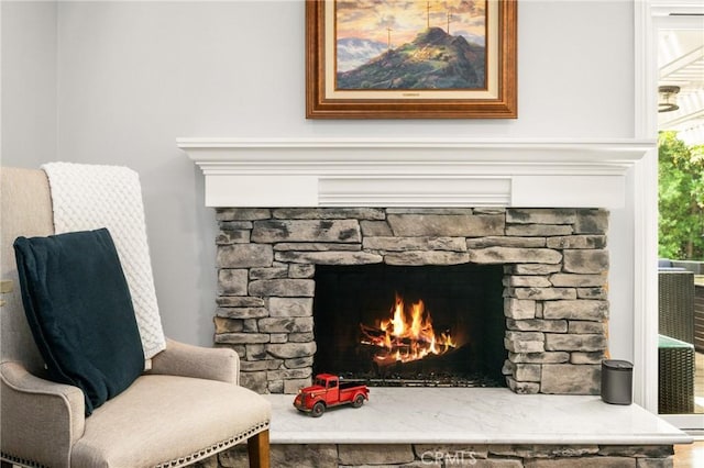 living area featuring a stone fireplace