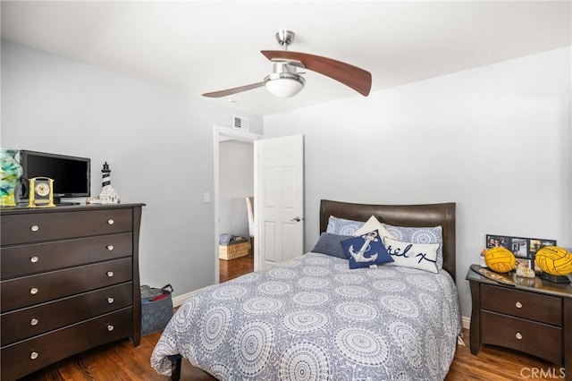 bedroom with ceiling fan and dark wood-type flooring