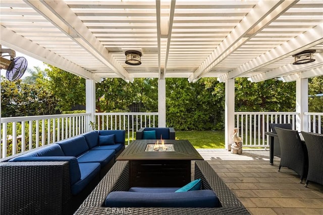 view of patio with an outdoor living space with a fire pit and a pergola