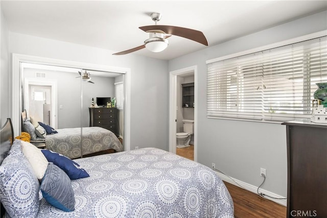 bedroom with ceiling fan, ensuite bathroom, a closet, and dark hardwood / wood-style flooring