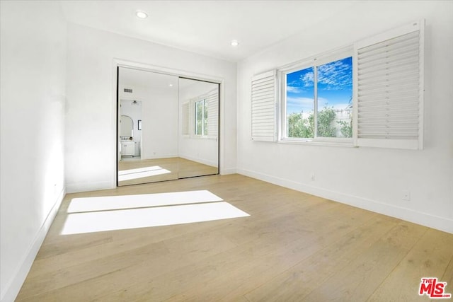 spare room with wood-type flooring