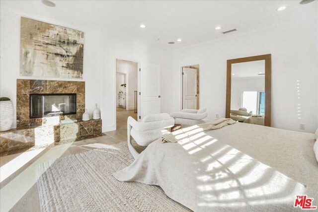 bedroom featuring a fireplace and crown molding