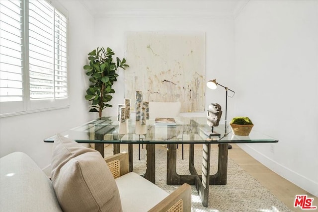 dining area with ornamental molding and hardwood / wood-style flooring