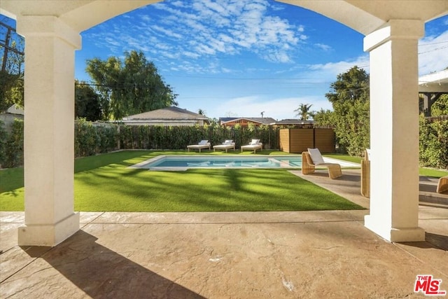 view of pool featuring a yard