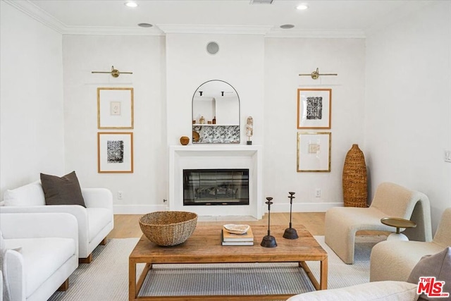 living room featuring light wood-type flooring and ornamental molding