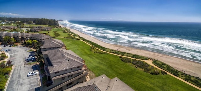 aerial view with a water view and a beach view