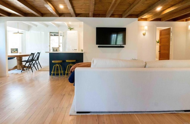 living room with wooden ceiling, beam ceiling, and light hardwood / wood-style floors