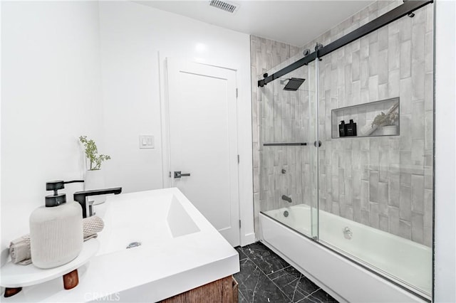 bathroom featuring bath / shower combo with glass door and vanity