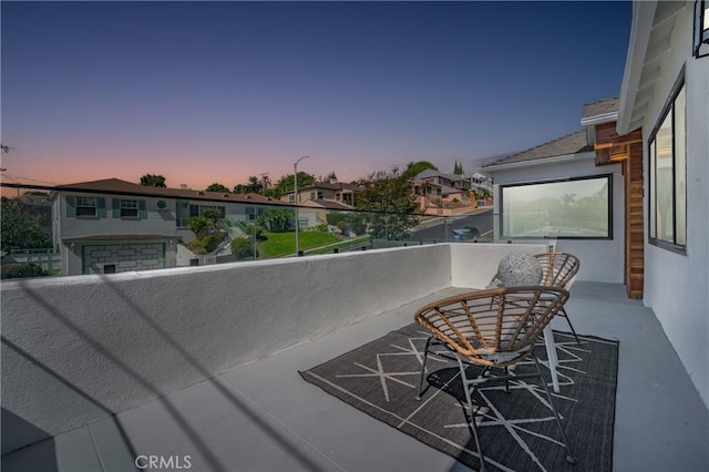 view of balcony at dusk