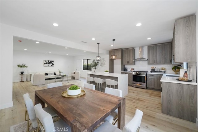 dining area with sink and light hardwood / wood-style flooring