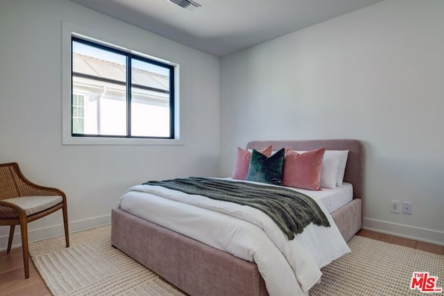 bedroom with light hardwood / wood-style floors