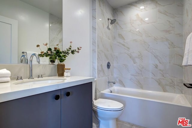 full bathroom with toilet, vanity, and tiled shower / bath