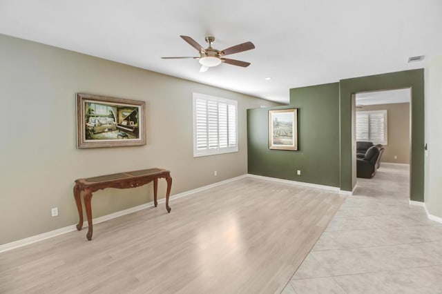 unfurnished room with ceiling fan and light wood-type flooring