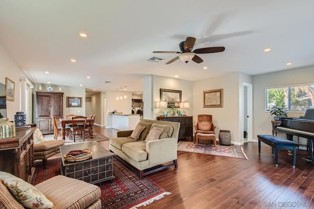 living room with dark hardwood / wood-style floors and ceiling fan