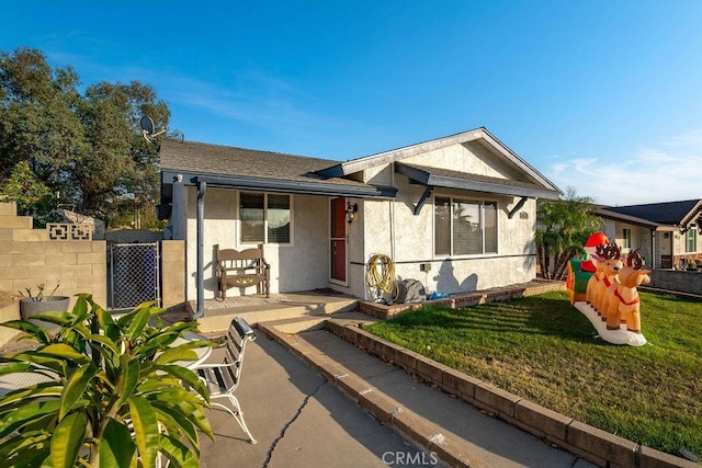 view of front of property with a patio and a front yard