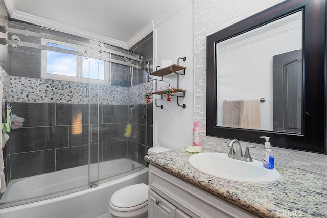 full bathroom with toilet, backsplash, bath / shower combo with glass door, crown molding, and vanity