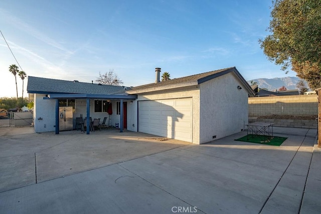 exterior space with a mountain view and a garage