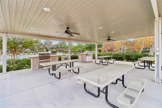 view of patio with ceiling fan, exterior kitchen, and grilling area