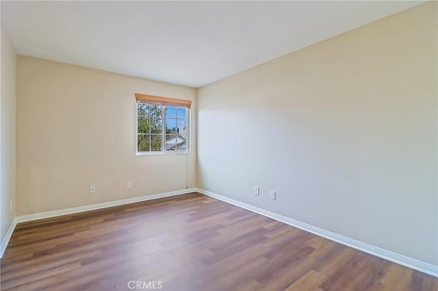 empty room with wood-type flooring