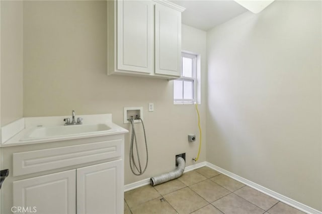 laundry room with cabinets, sink, hookup for a washing machine, and light tile patterned flooring