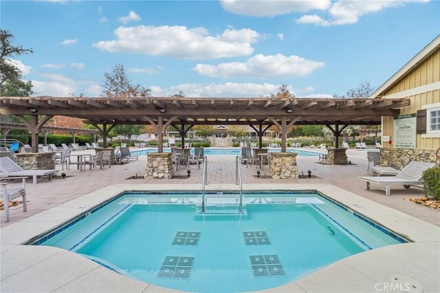 view of swimming pool featuring a pergola