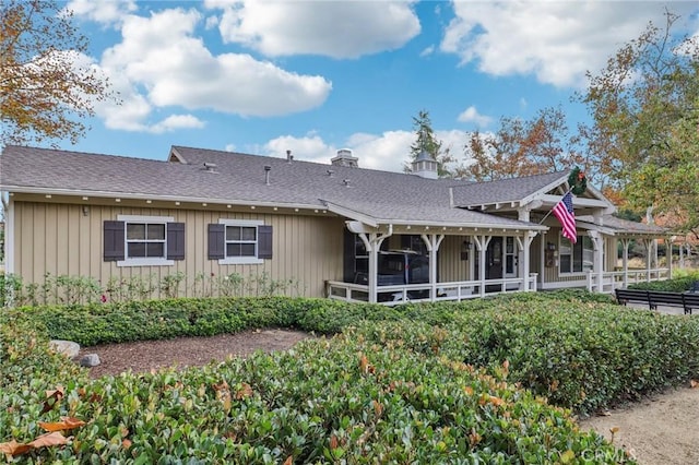 back of house featuring a sunroom