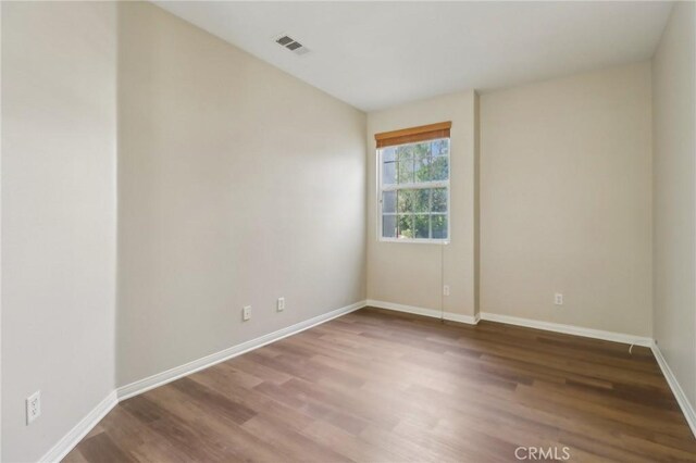 spare room featuring hardwood / wood-style flooring