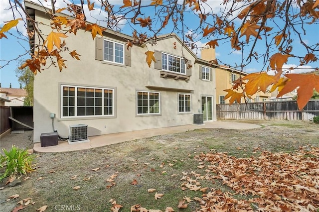 rear view of house with a patio area and central AC