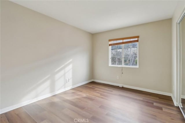 spare room featuring light wood-type flooring