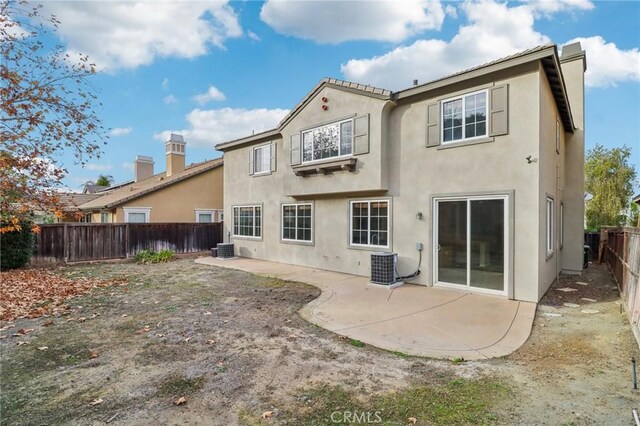 back of property featuring central air condition unit and a patio