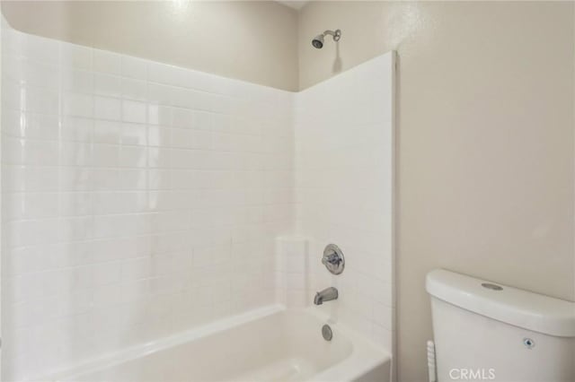 bathroom with shower / bathing tub combination and toilet