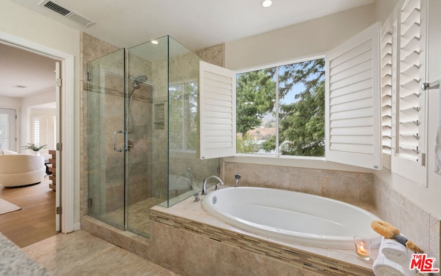 bathroom featuring plus walk in shower and tile patterned floors