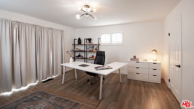 home office featuring an inviting chandelier and dark hardwood / wood-style floors