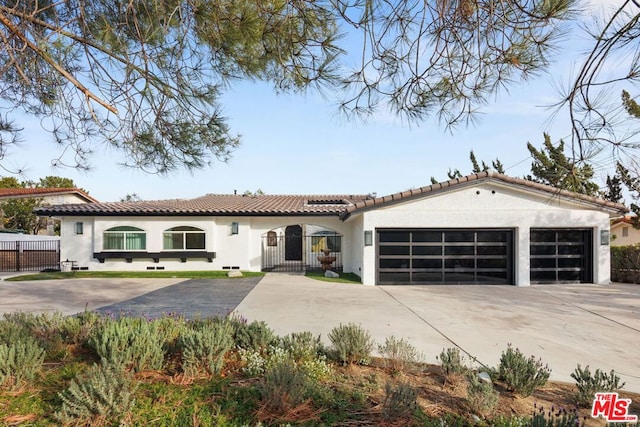 mediterranean / spanish-style home featuring a garage