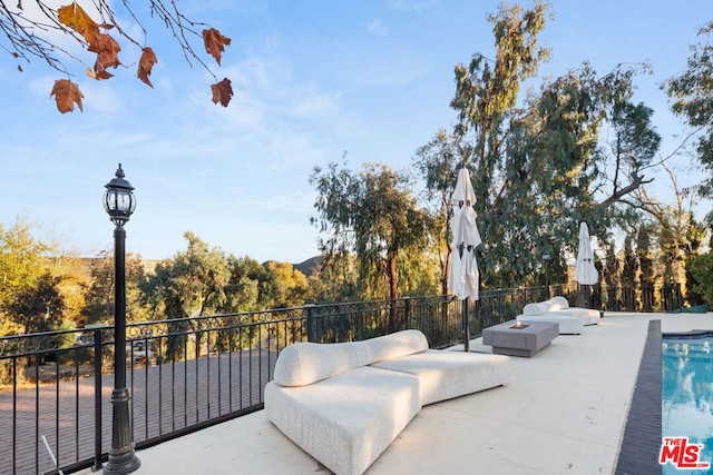 view of patio / terrace with a fenced in pool